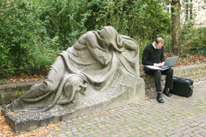 Man Working by Reclining Statue